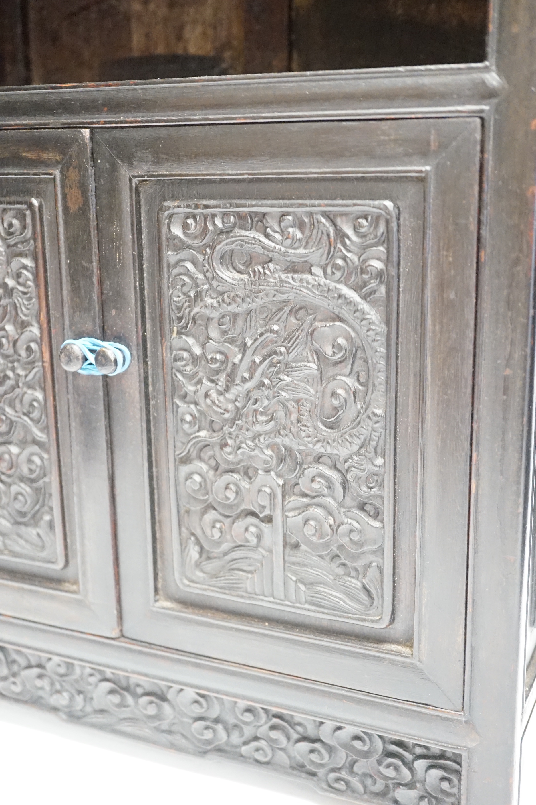 An early 20th century Chinese hongmu cabinet with carved cupboard doors, 61cm high